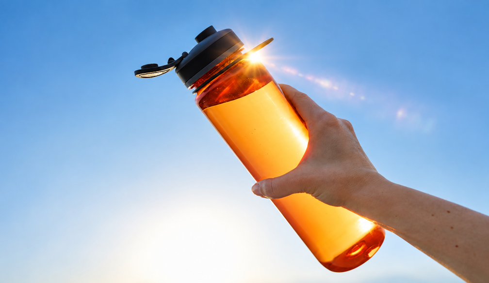 Sunlit Amber Bottle Against Blue Sky