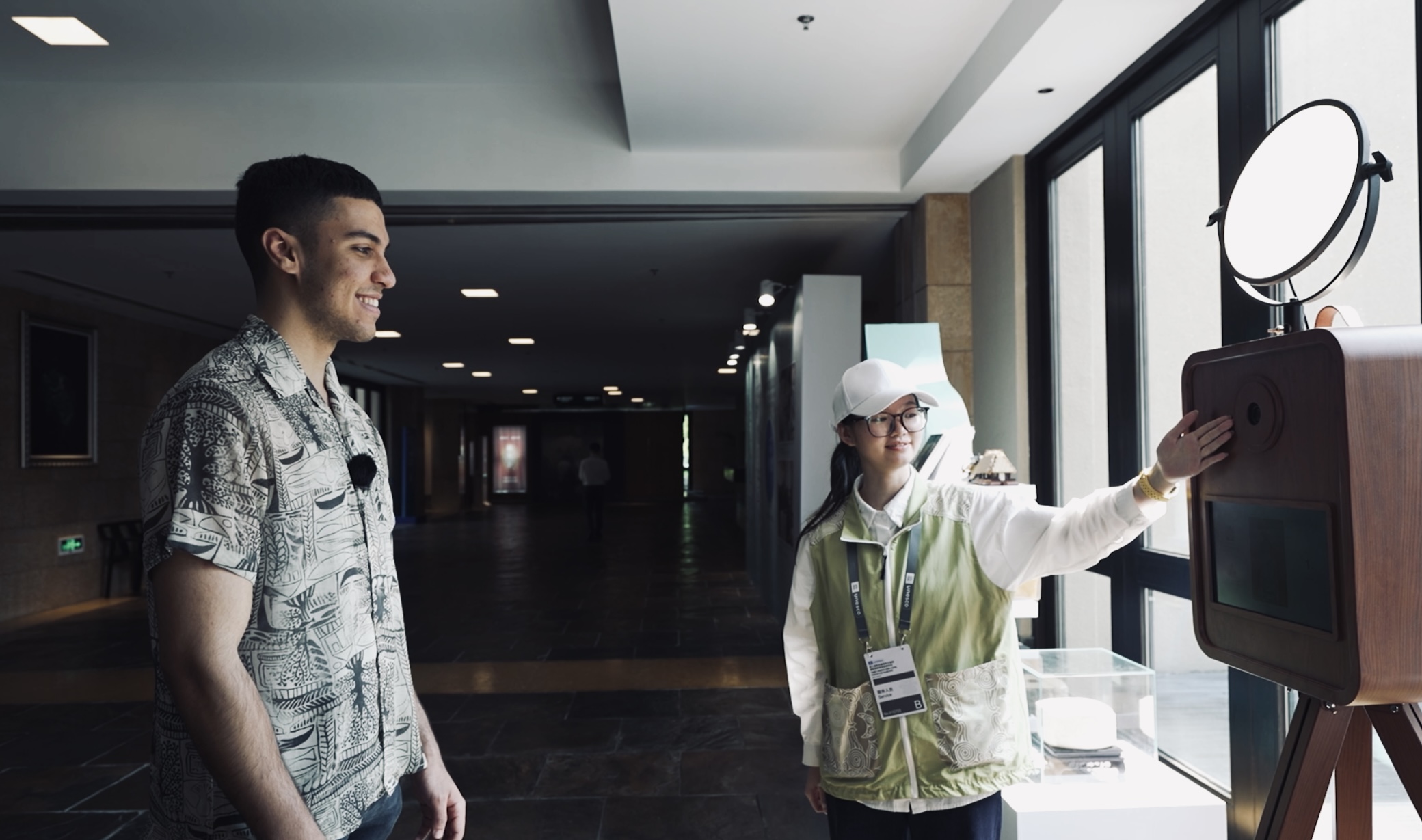 Moroccan youth Aymene engaged with the "Liangzhu Ancestors AI Face Swap Generator" at Liangzhu Museum, using artificial intelligence to create a personal portrait infused with Liangzhu cultural elements.