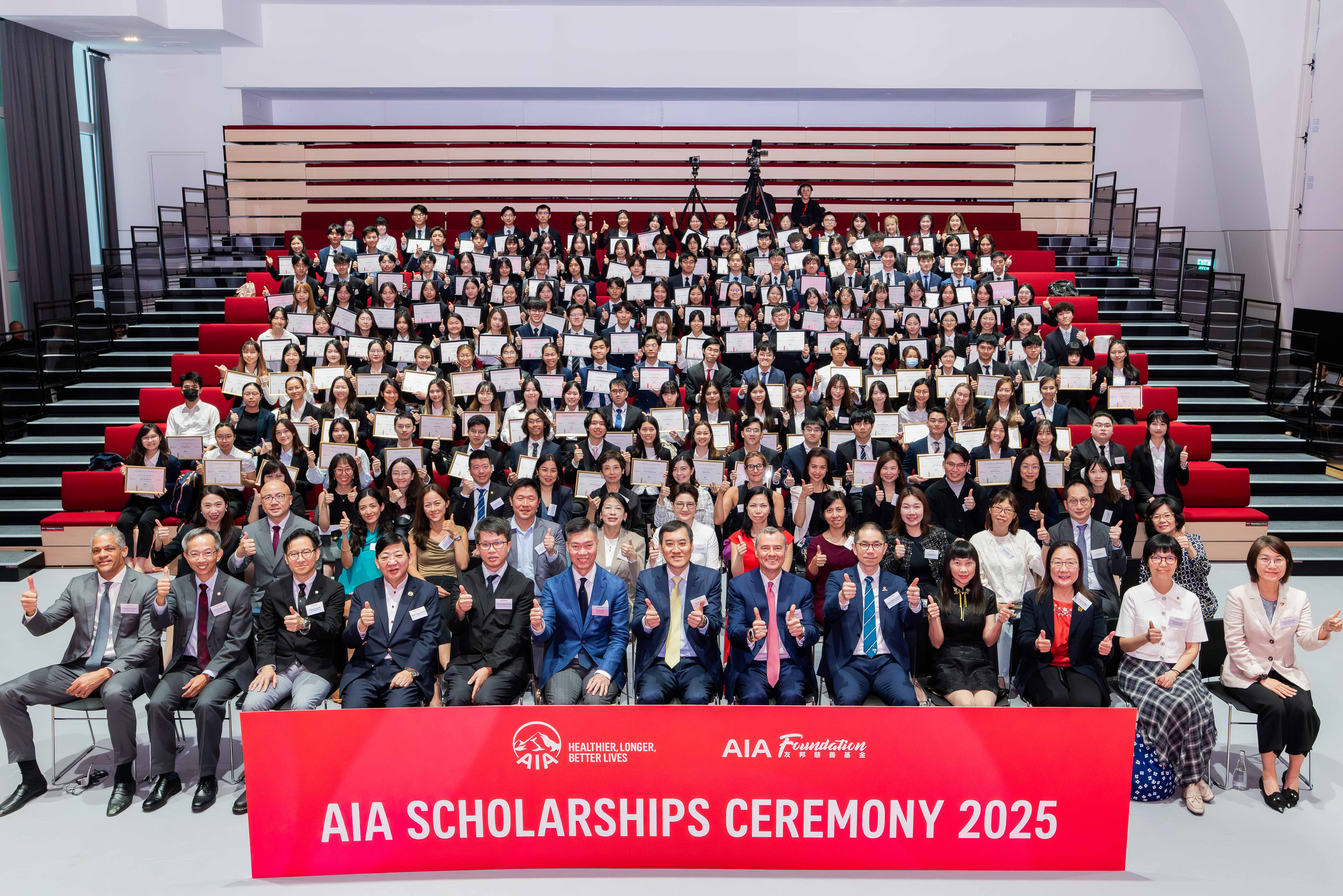 Group photo of representatives from AIA Foundation, university representatives, representatives from partners, AIA Scholars, and graduates.