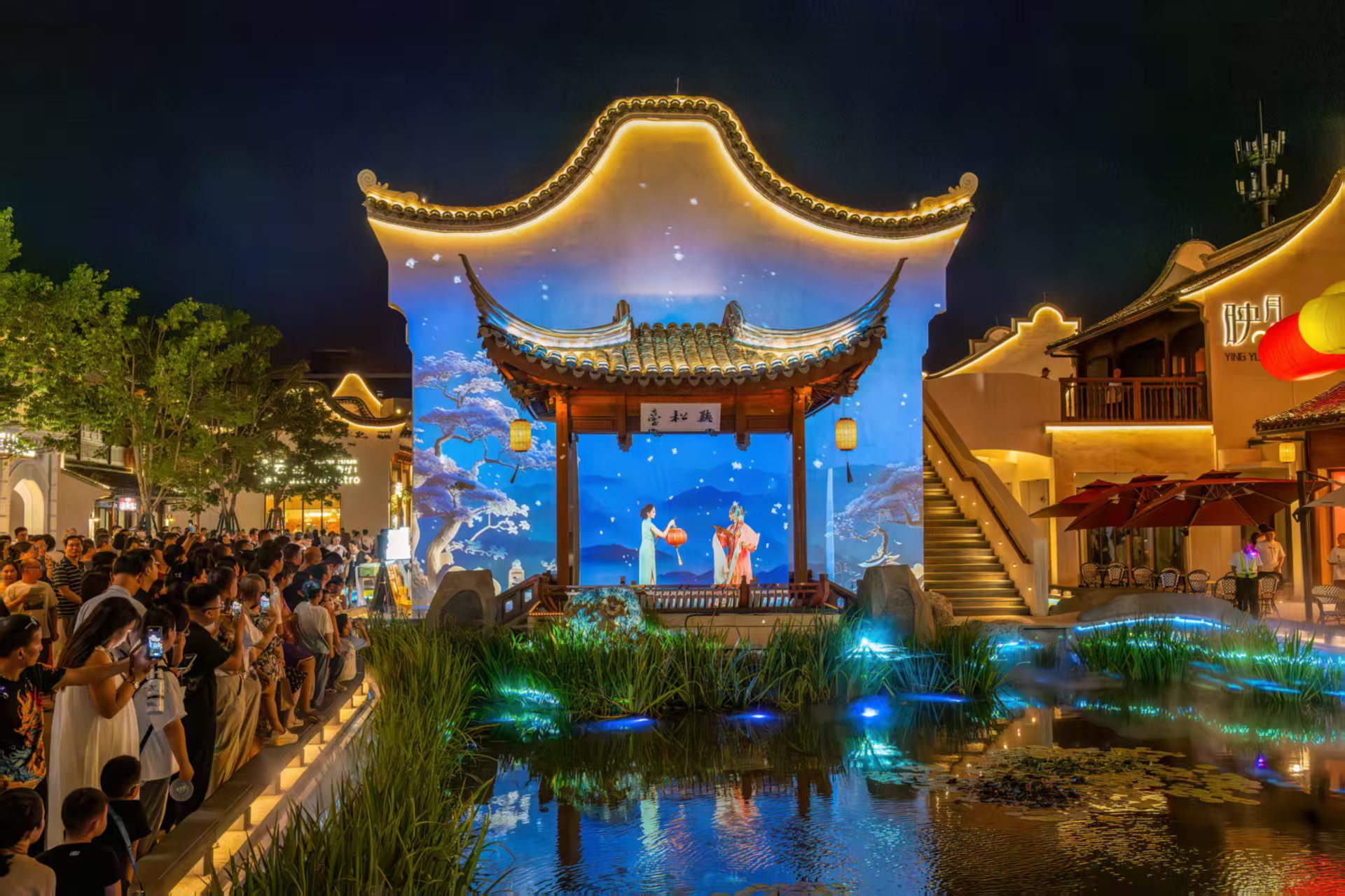 Spectators gather to watch a performance of Wuxi Opera at the modern YingYueli Cultural Block in Liangxi, China.
