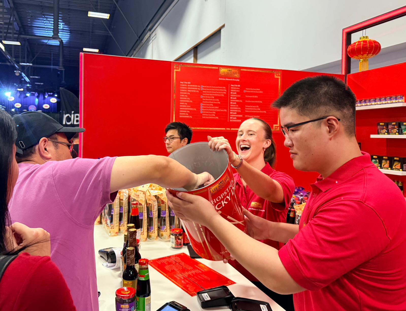 A visitor tries his luck by drawing chopsticks from the luck dip game.