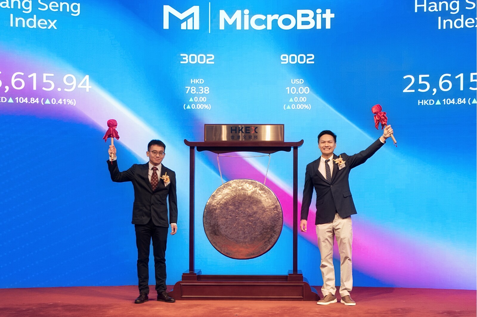 MicroBit Group CEO (right 1) and COO (left 1) striking the Gong