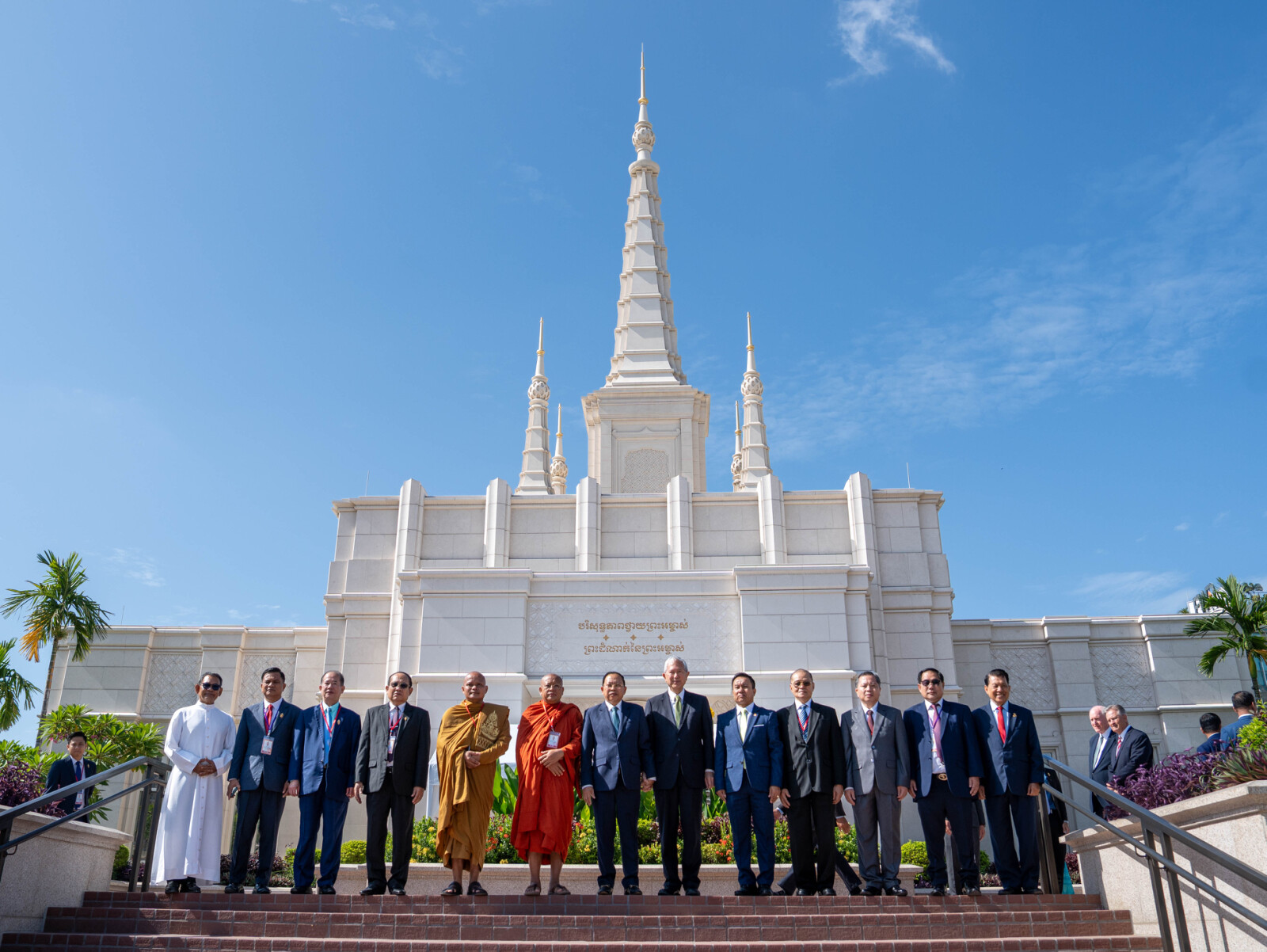 A diverse group of government and interfaith leaders pose for a photo in front of the Phnom Penn Cambodia Temple on Wednesday, Aug. 12, 2026, during the temple