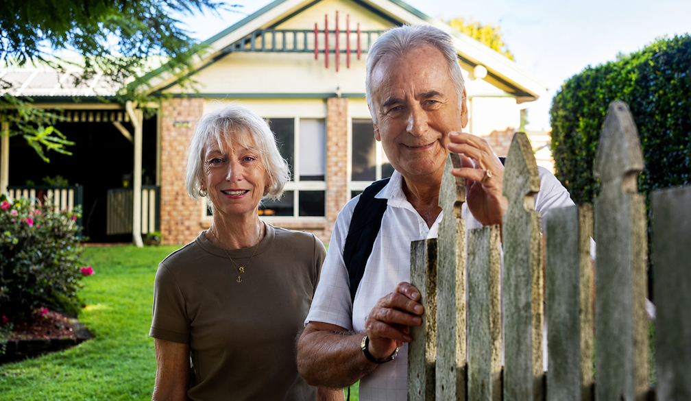 Smiling Seniors by the Garden Fence