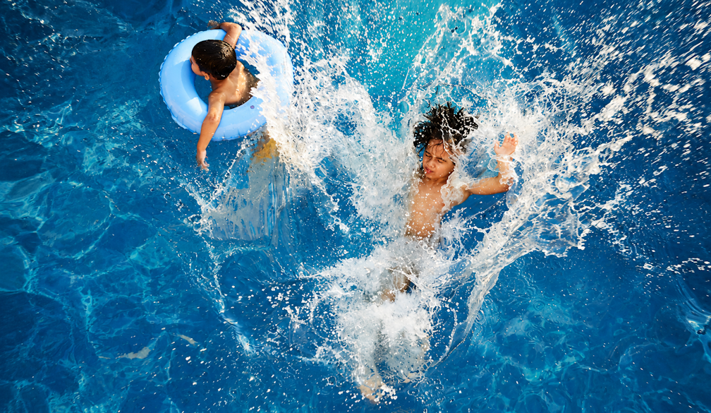 Sunlit Pool Splash with Two Children